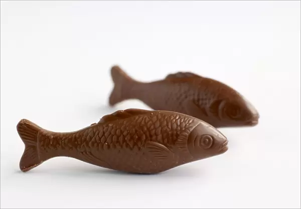 Two chocolate fish, side view