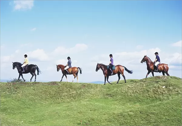 Four Riders on Ponies Riding Along Bridleway