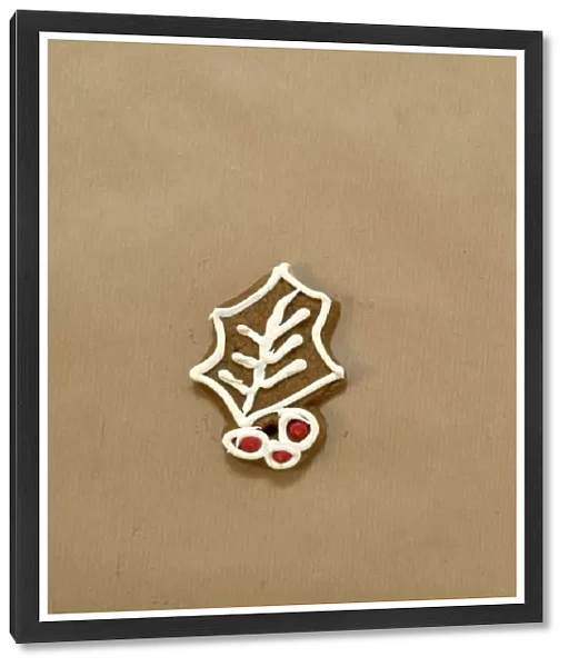 Iced gingerbread biscuit in shape of holly leaf
