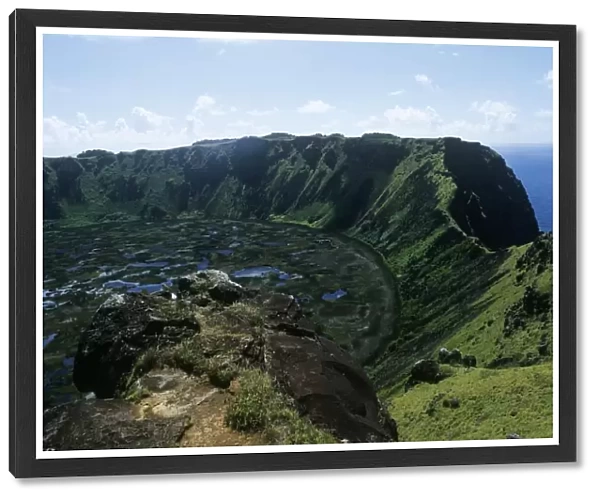 Chile, Easter Island, Rapa Nui National Park, Rano Kau volcano, Aerial view of volcano crater with blue sea in background
