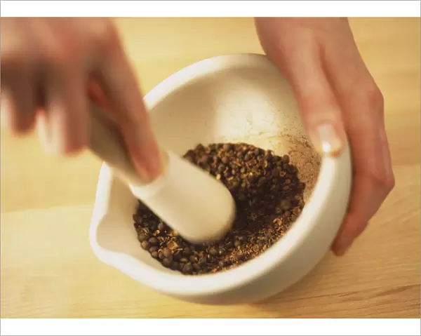 Using pestle and mortar to grind seeds, blurred motion
