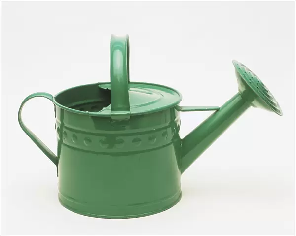 Green metal watering can, side view