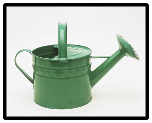 Green metal watering can, side view