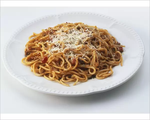 Plate of spaghetti bolognese sprinkled with grated cheese