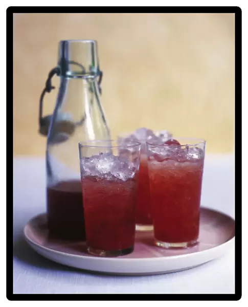 Bottle and three glasses of cherry sharbat, on a plate
