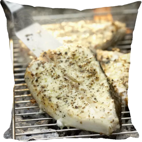 Halibut steaks on barbecue grill, spatula