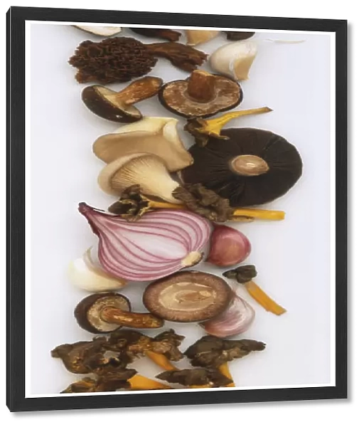 Half a Red Onion, cloves of Garlic and a selection of mushrooms, including chanterelles, shiitake, morels and oyster mushrooms