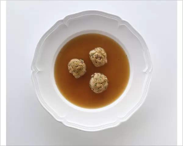 Leberknoedelsuppe, bowl of broth containing three dumplings made from beef liver