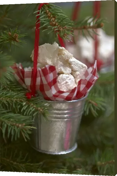 Nougat sweets hanging from tree in silver pot
