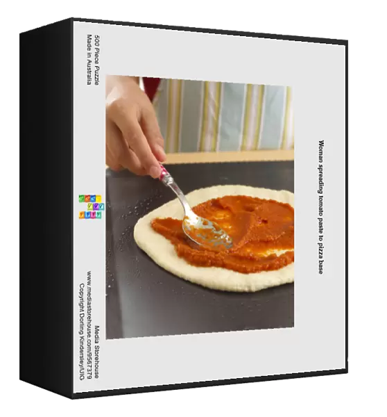 Woman spreading tomato paste to pizza base