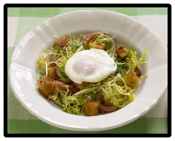 Bistro salad with frisee lettuce, poached egg, bacon lardons and croutons
