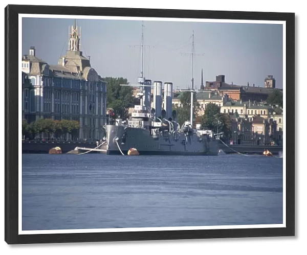 Russia, St Peterburg, the historic cruiser Aurora moored in front of the Neo-Baroque Nakhimov Naval Academy