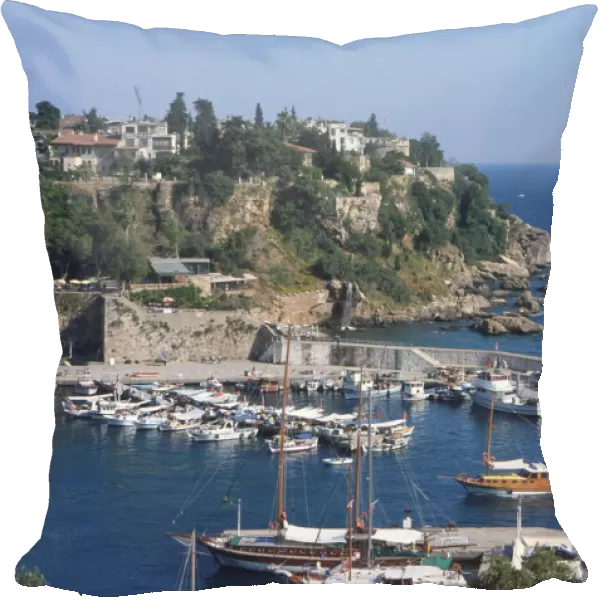 Turkey, Western Mediterranean Coast, Antalya, yachts in historic old harbour below remnants of city walls, elevated view