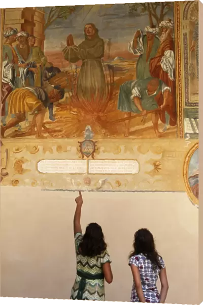 Mother and daughter looking at a fresco