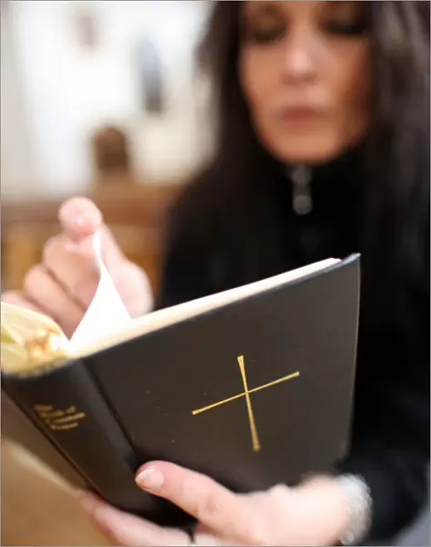 Woman reading the bible in a church