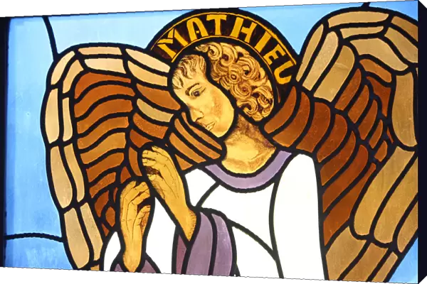 Stained glass depicting evangelist Saint-Matthew symbolised by an angel