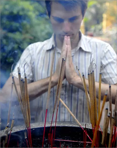 Westerner praying in a Vietnam temple