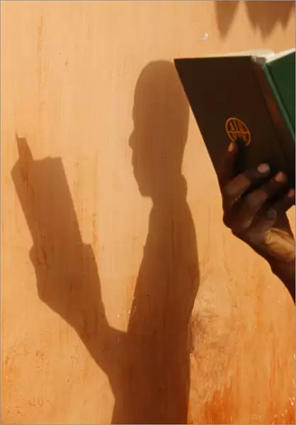 African man reading the bible