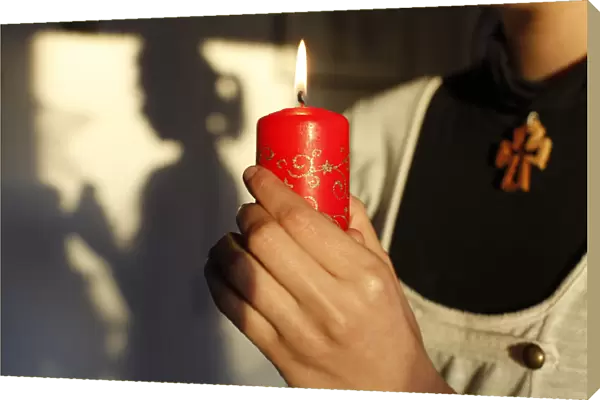Girl holding a Christmas candle