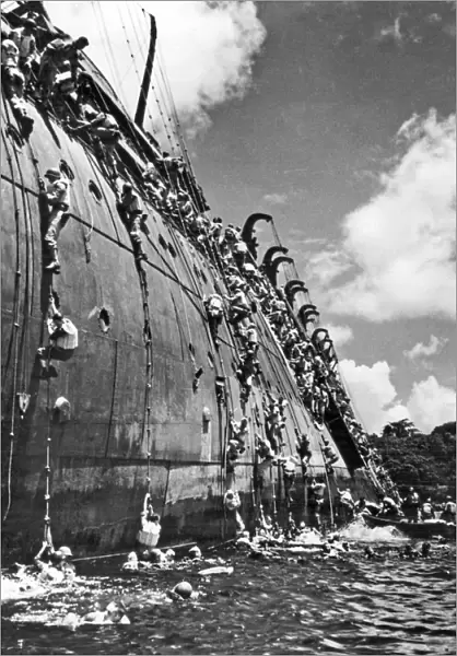 The troop carrier, USS President Coolidge goes down in the harbor at Espiritu Santo in the South Pacific after hittng a friendly mine