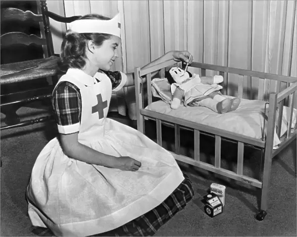 A young girl plays nurse to her Little Lulu doll