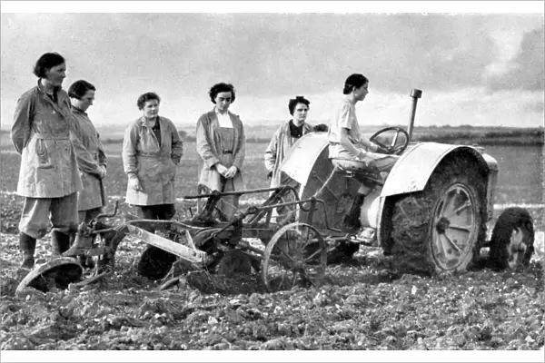 British girls of the Womens Land Army learning to plough with a tractor. World