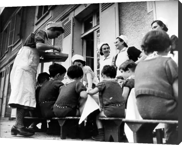 Children at home run by the German Ministry of Health being served a meal outside