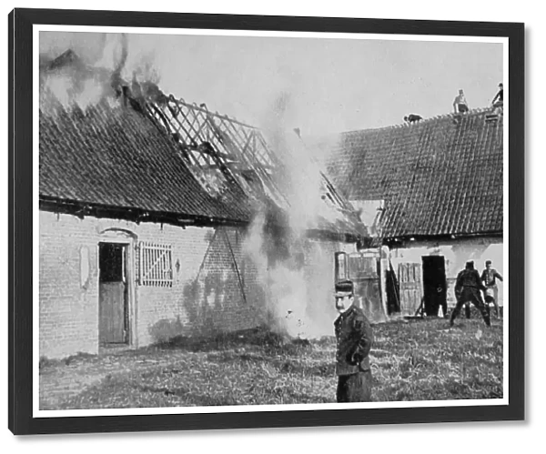 World War I 1914-1918: Fighting a fire on a farm in Artois, France, set alight by German shellfire