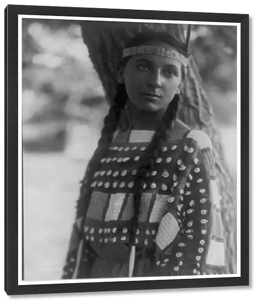 Young Native American woman, half-length, portrait, standing, facing front, 1907