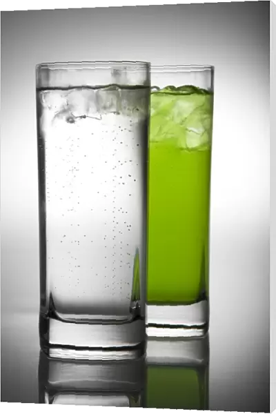 lemonade and green drink in pair of glasses
