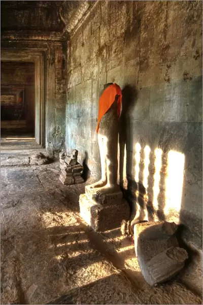 Sunlight Shining Onto The Headless Statue in Angkor Wat, Siem Reap, Cambodia