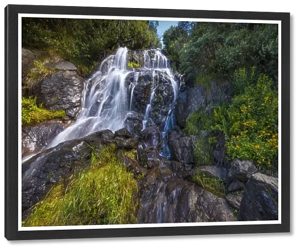 Flowing water over Falls Creek waterfall in the Alpine mountainous region of north east Victoria, Australia