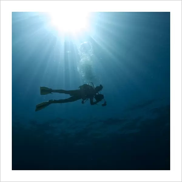 Scuba diver with sun burst