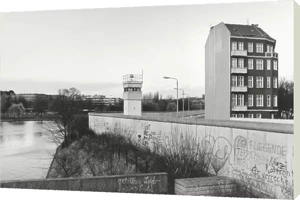 View over the Berlin Wall in 1985, detached house next to a watchtower adjacent to the inner German border, known as the Death Strip, Berlin, Germany, Europe