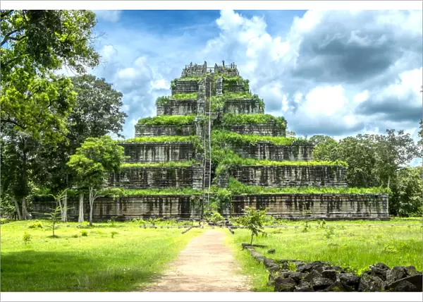 Overgrown stone temple in remote field, Srayong Cheung, Preah Vihear, Cambodia