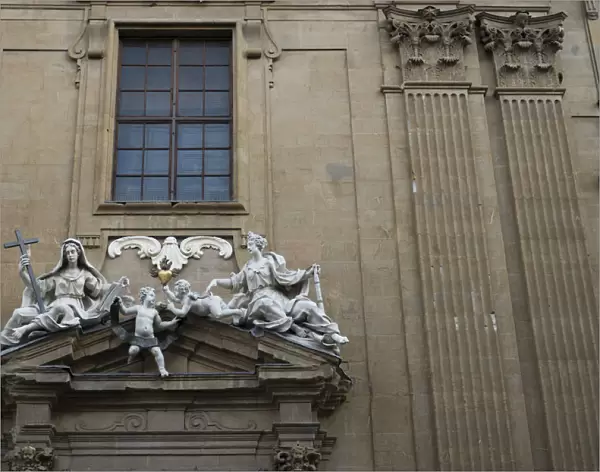 White marble sculptures on the facade of a building in Florence