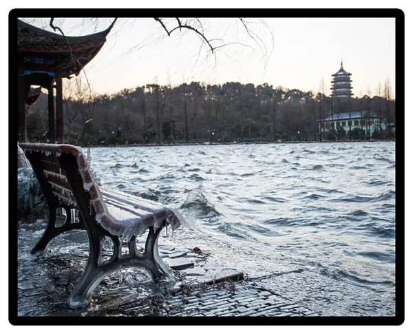 Icicles on bench against the Leifeng Pagoda by the West Lake, Hangzhou, Zhejiang, China