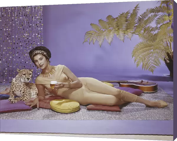 Young woman lying on cushion with leopard