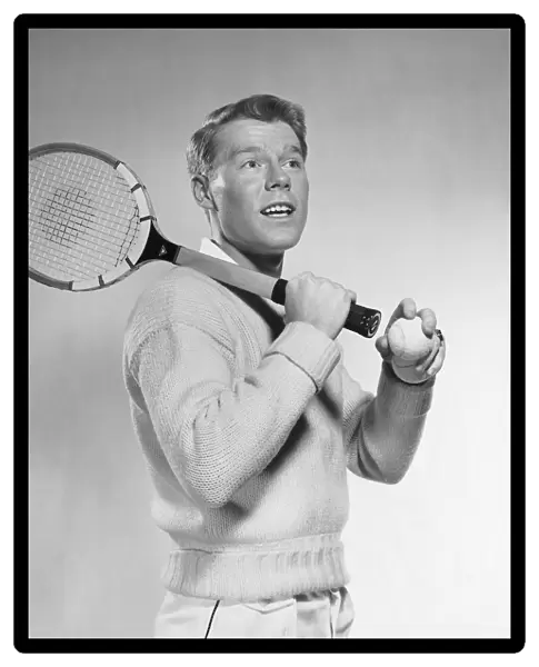 Man holding tennis racket over his shoulder