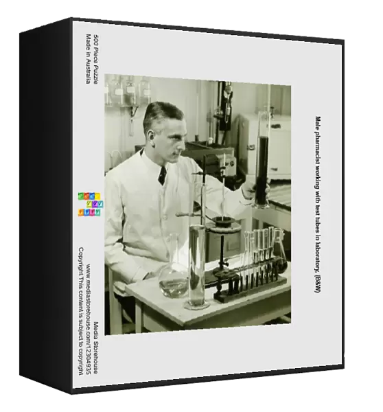 Male pharmacist working with test tubes in laboratory, (B&W)