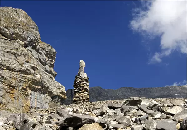 Cairn as signpost and orientation help in rocky alpine terrain without trails, Valais, Switzerland, Europe