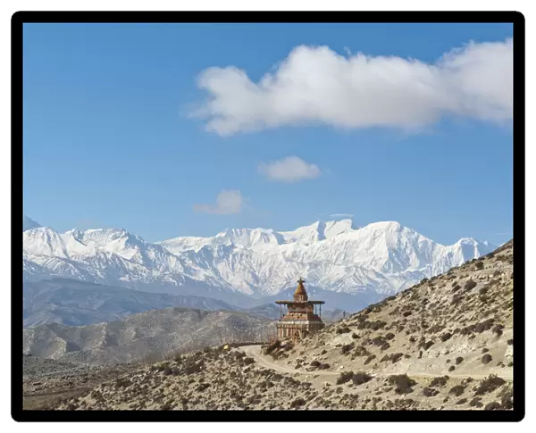 Vast landscape with stupa, the snow-covered mountains of the Annapurna Range at back, near Geling, Upper Mustang, Lo, Nepal
