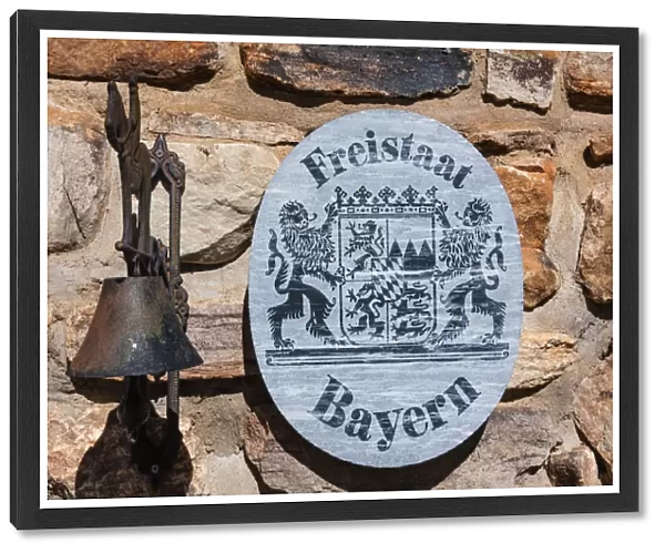 Sign Freistaat Bayern, English for Free State of Bavaria with a bell on a natural stone wall, Namibia