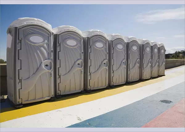 Row of portable toilets outdoors, Montreal, Quebec Province, Canada