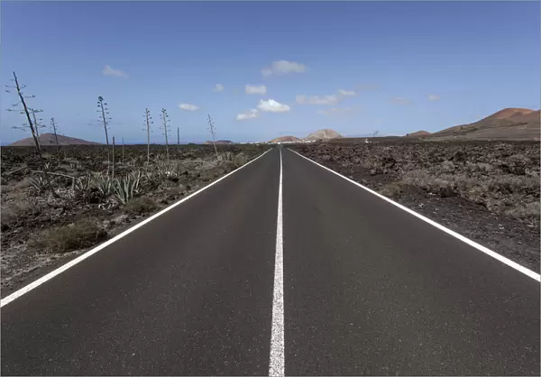 Road through volcanic landscape, near Mancha Blanca, Lanzarote, Canary Islands, Spain