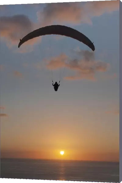 Paraglider over the Atlantic Ocean with sunset, Canary Islands, Spain