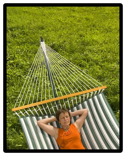 Senior woman listening to music in a hammock