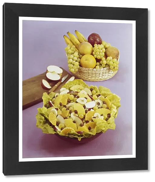 Fruit salad and basket against pink background, , close-up