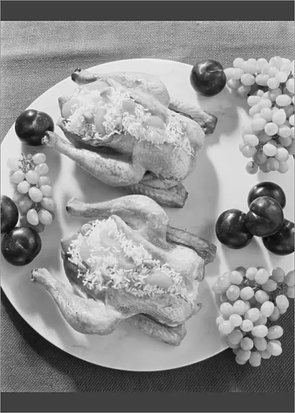 Stuffed chicken and fruits in plate, close-up