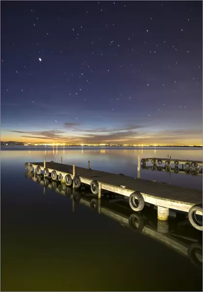 Wooden pier on a lake in the night